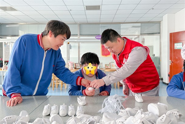 03 圖為志愿者幫助特殊兒童做手工